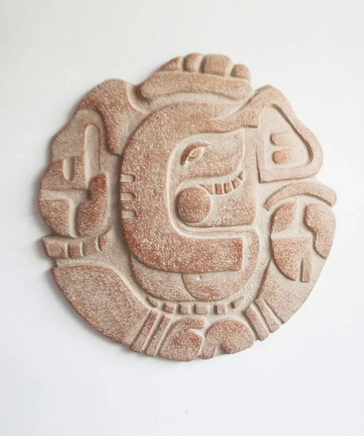 Carved stone medallion with a glyph pattern